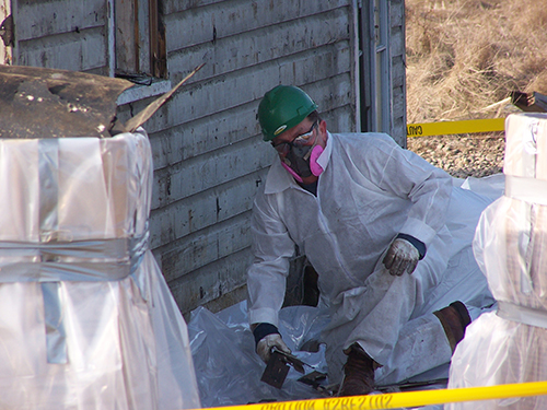 man with protective gear doing asbestos removal